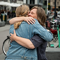Two women hugging in the street